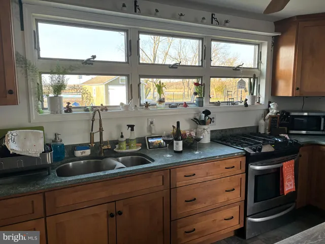 a kitchen with granite countertop a sink and a window