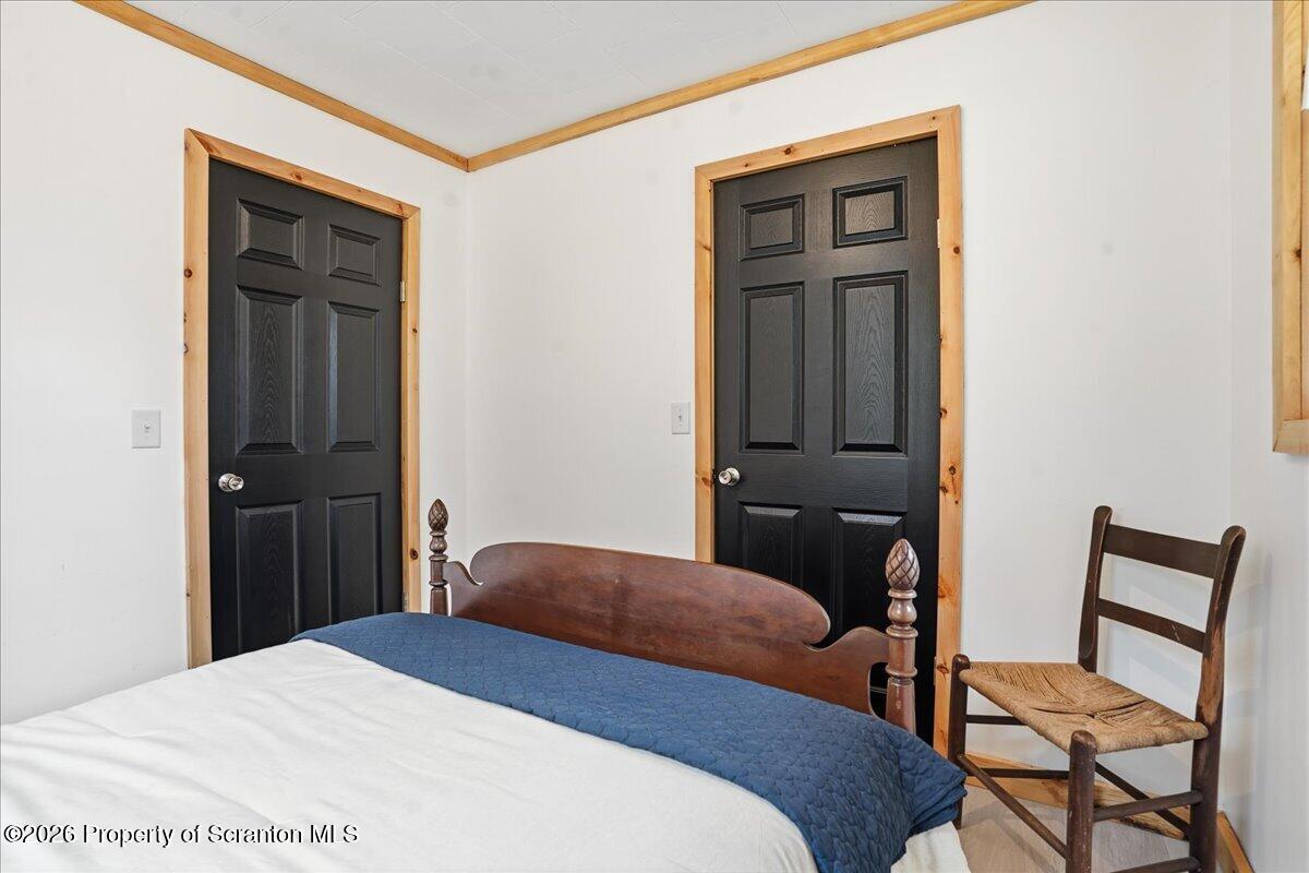 232 Starrucca Creek Road Starrucca, PA 18462 - Photo 12 of 64 a bedroom with a bed and chair