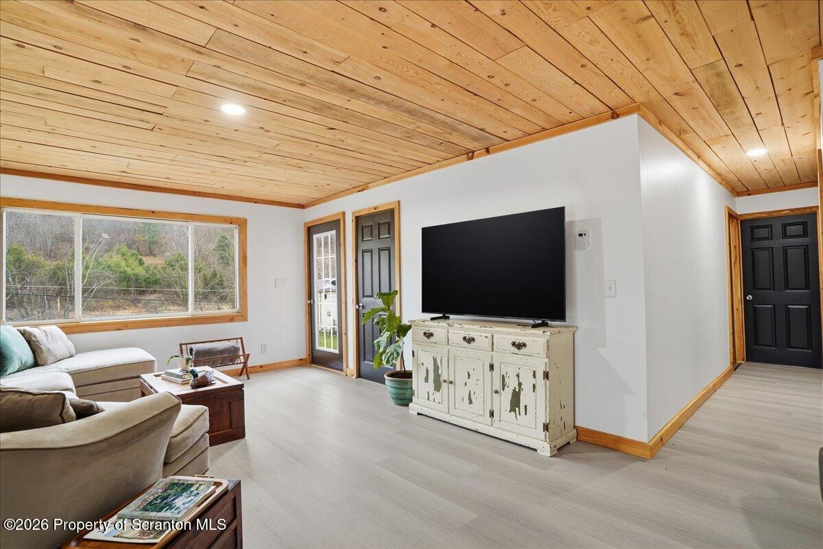 232 Starrucca Creek Road Starrucca, PA 18462 - Photo 27 of 64 a living room with furniture and a flat screen tv