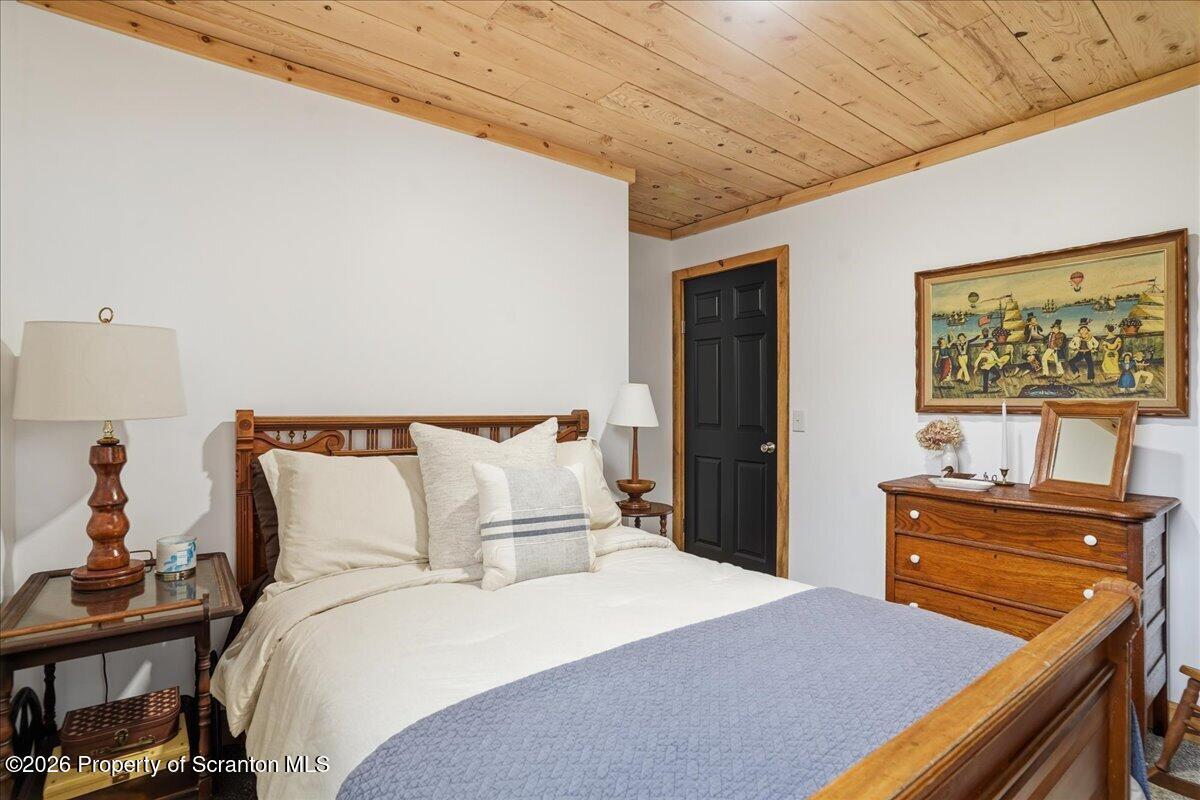 232 Starrucca Creek Road Starrucca, PA 18462 - Photo 33 of 64 a bedroom with a bed and a dresser in it