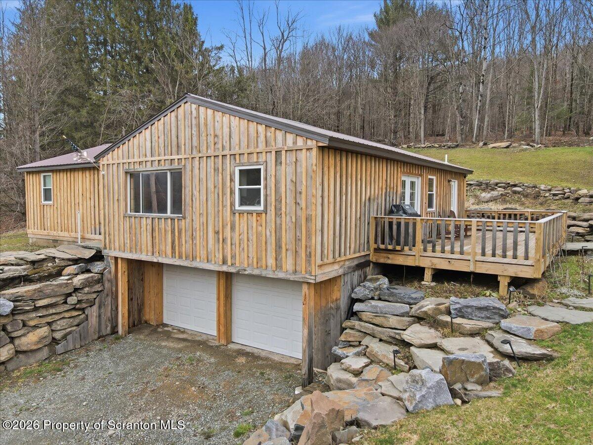 232 Starrucca Creek Road Starrucca, PA 18462 - Photo 6 of 64 a backyard of a house with wooden deck and outdoor seating