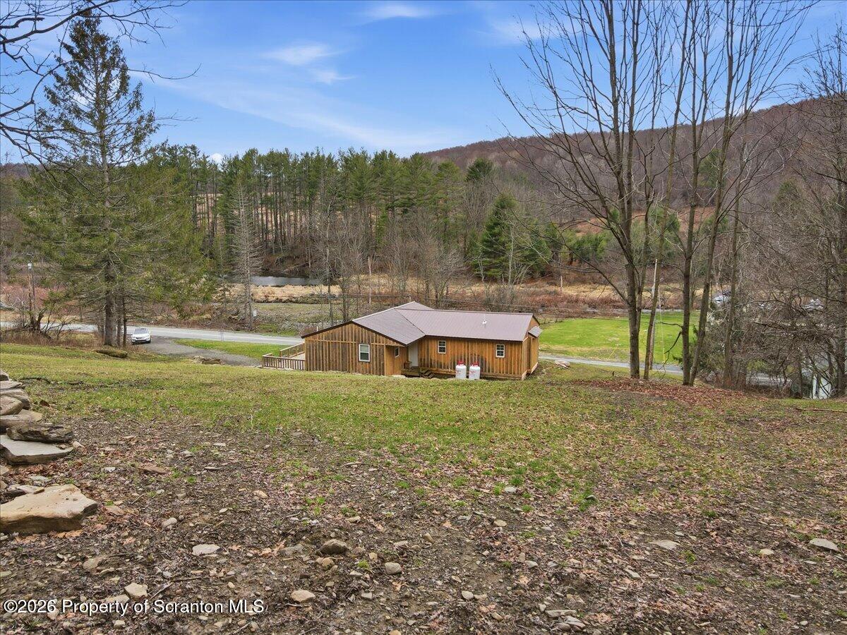 232 Starrucca Creek Road Starrucca, PA 18462 - Photo 61 of 64 a backyard of a house with a yard and outdoor seating