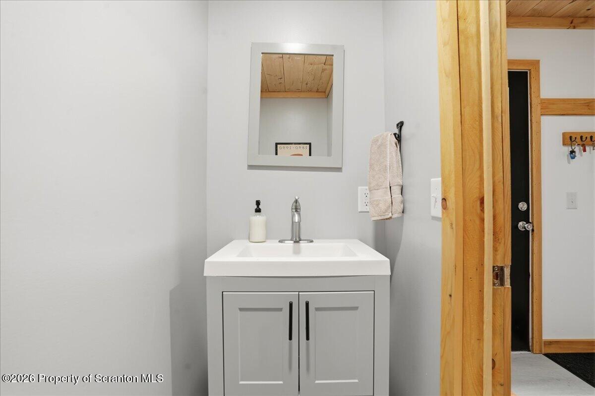 232 Starrucca Creek Road Starrucca, PA 18462 - Photo 10 of 64 a bathroom with a sink a vanity and a mirror