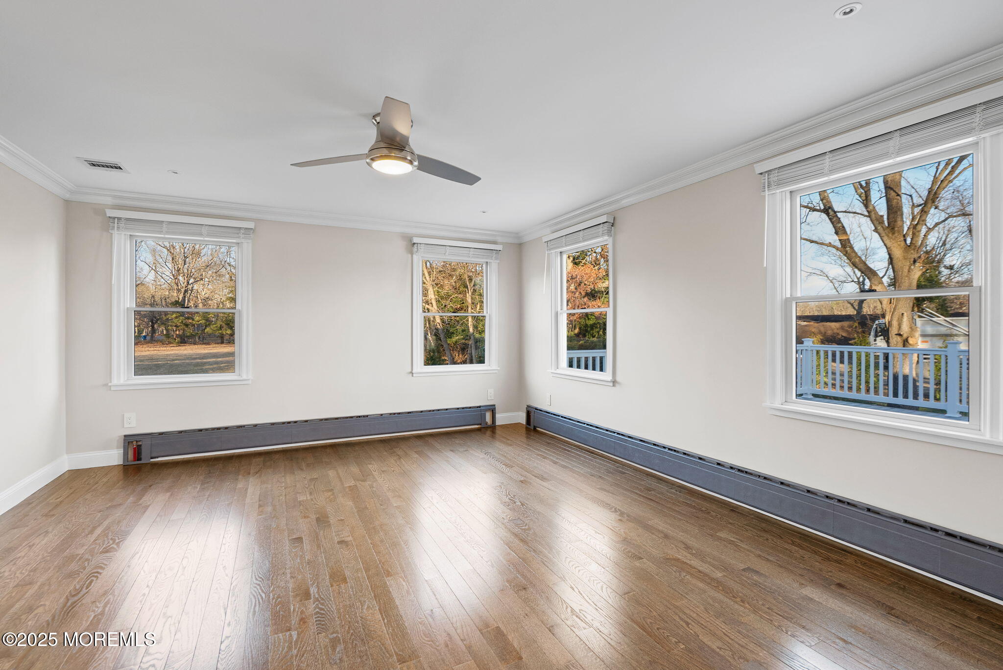 458 Newtons Corner Road Howell, NJ 07731 - Photo 21 of 44 a view of an empty room with wooden floor and a window