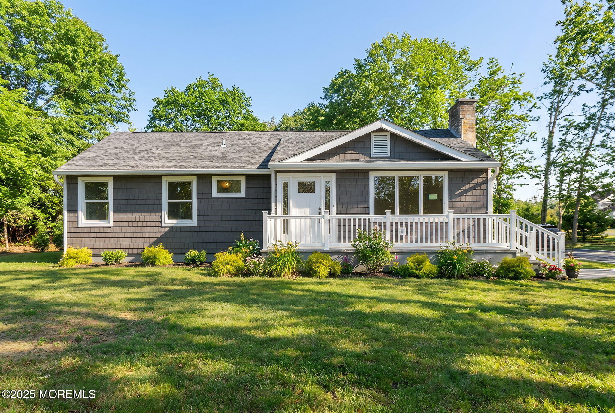 458 Newtons Corner Road Howell, NJ 07731 - Photo 3 of 44 a front view of a house with a garden and trees
