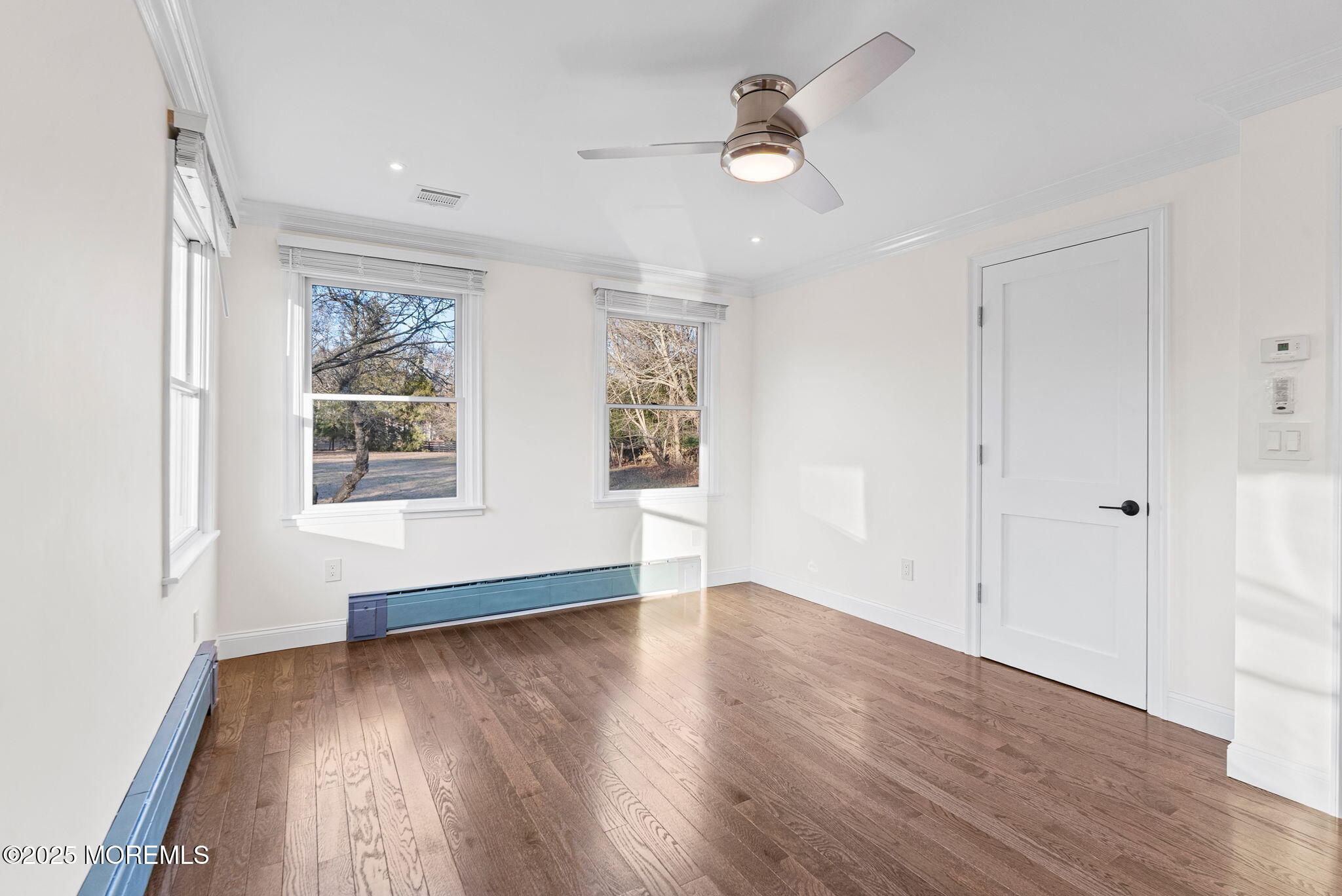 458 Newtons Corner Road Howell, NJ 07731 - Photo 35 of 44 an empty room with wooden floor chandelier fan and windows