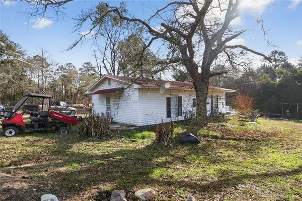 a view of backyard of house with green space