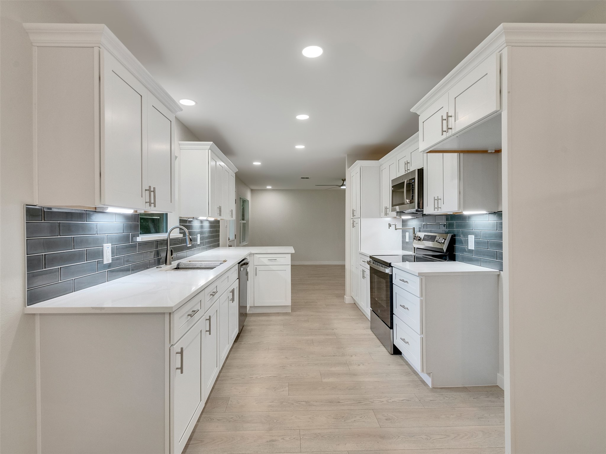 10315 Winding Trail Road La Porte, TX 77571 - Photo 7 of 24 Experience modern elegance in this kitchen with sleek quartz countertops, soft-close cabinets, and a stunning subway tile backsplash.