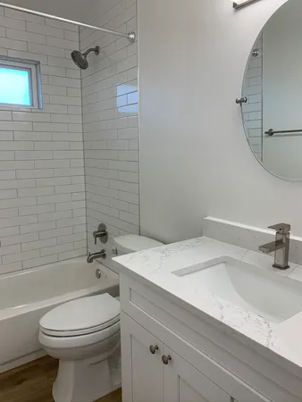 a house that has a tree in front of a house