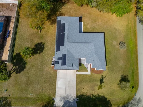 aerial view of a house with a yard