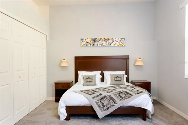 a bedroom with a bed and a night stand