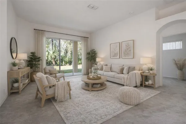 a living room with furniture and a large window