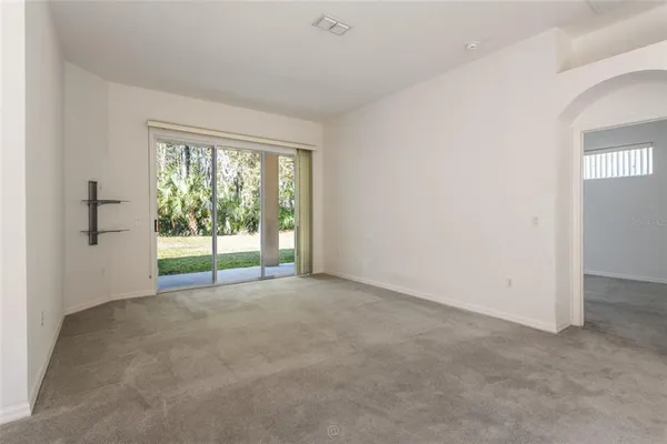 a view of an empty room with glass door