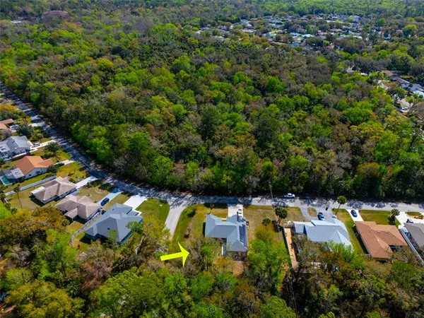 an aerial view of a house with a swimming pool