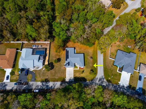 an aerial view of a house with swimming pool and outdoor space