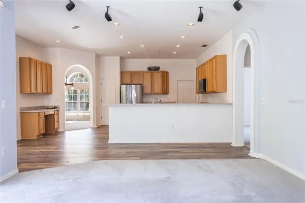 a view of kitchen with microwave and cabinets