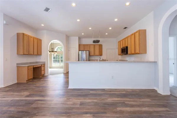 a view of kitchen with microwave and cabinets