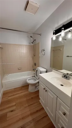 a bathroom with a double vanity sink mirror and toilet