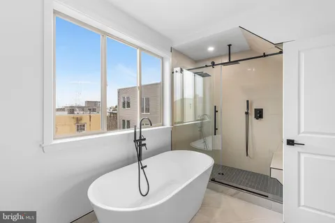 a bathroom with a sink and a glass door shower