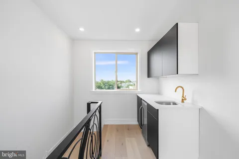 a kitchen with a sink a stove and cabinets