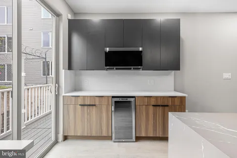 a living room with a stove and a refrigerator