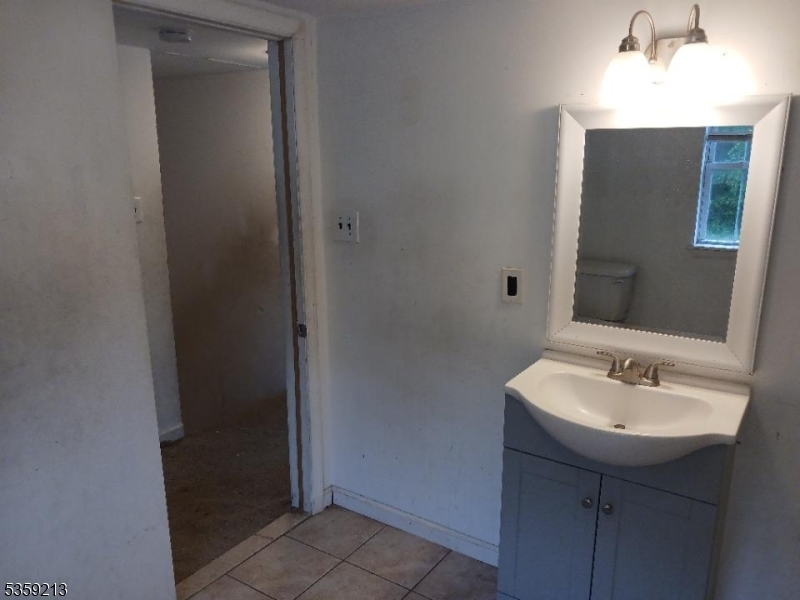 792 Paulsboro Road Swedesboro, NJ 08085 - Photo 11 of 13 a bathroom with a sink and a mirror