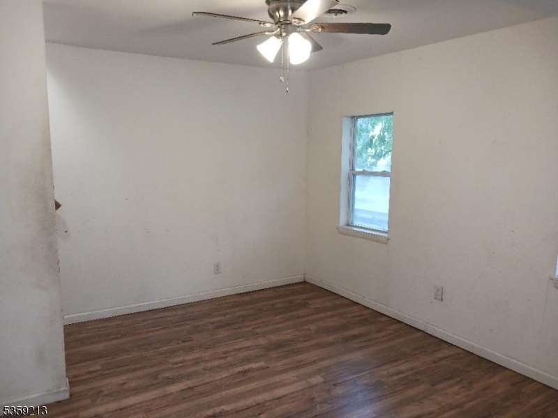 792 Paulsboro Road Swedesboro, NJ 08085 - Photo 9 of 13 wooden floor in an empty room with a window