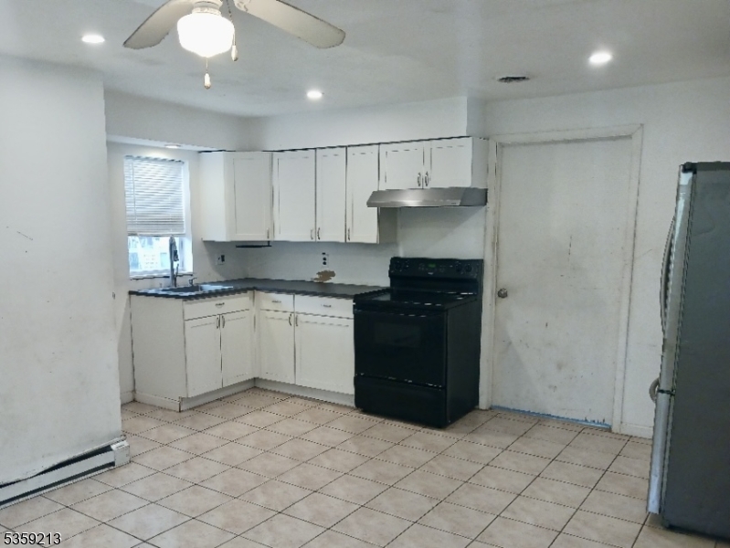 792 Paulsboro Road Swedesboro, NJ 08085 - Photo 10 of 13 a kitchen with a refrigerator and a stove