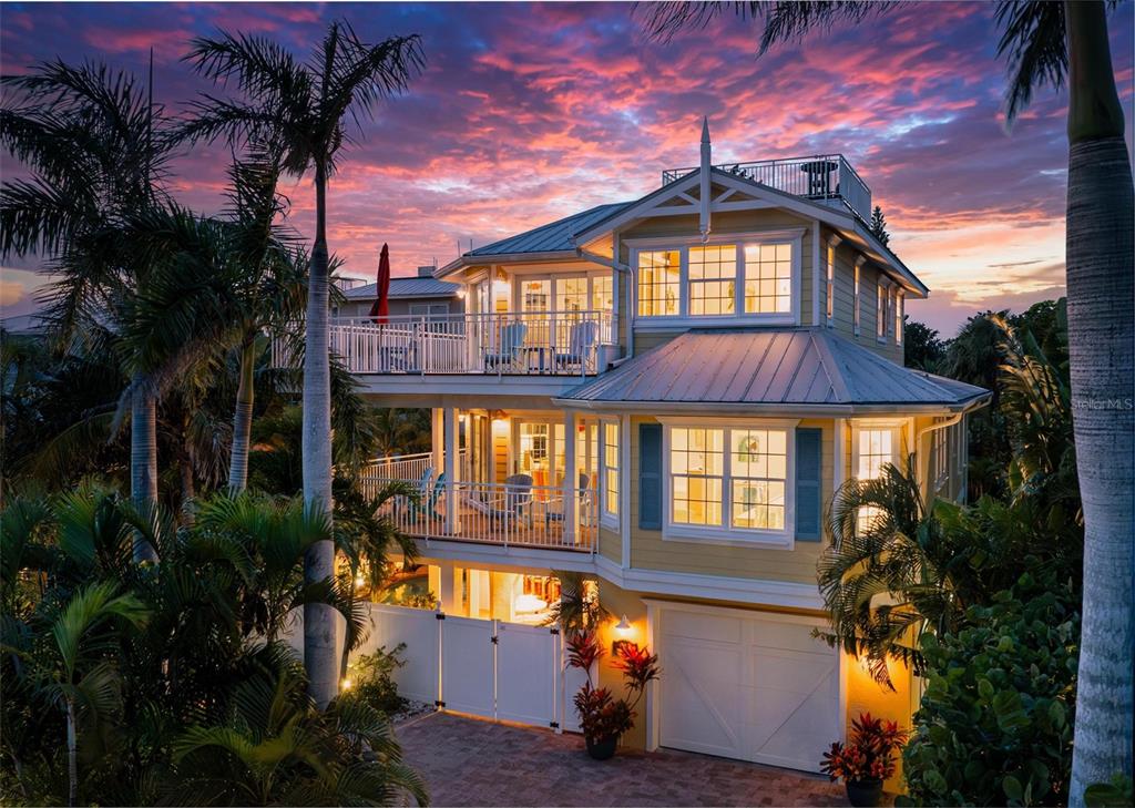 106 79th Street Holmes Beach, FL 34217 - Photo 1 of 98 a front view of a house with a yard