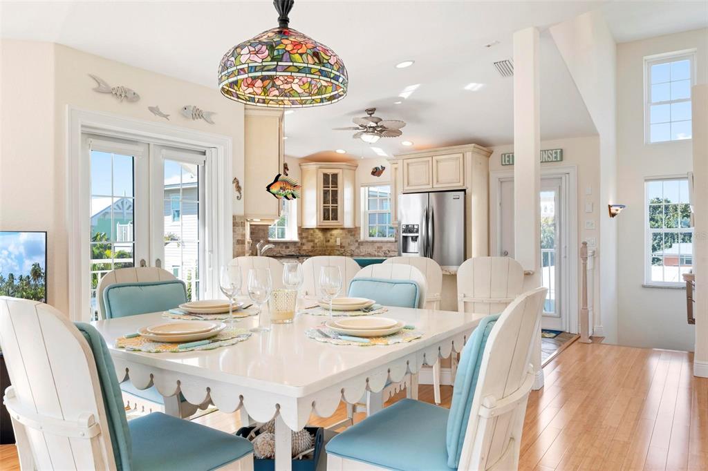106 79th Street Holmes Beach, FL 34217 - Photo 11 of 98 a view of a dining room with furniture wooden floor and chandelier
