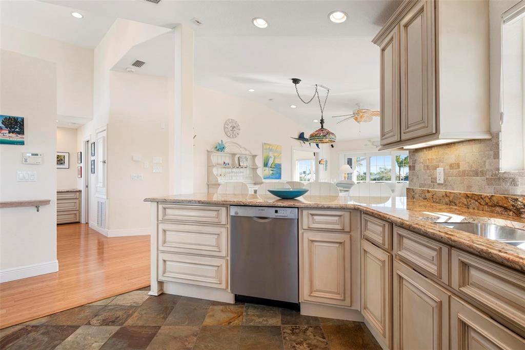 106 79th Street Holmes Beach, FL 34217 - Photo 14 of 98 a kitchen with white cabinets and sink