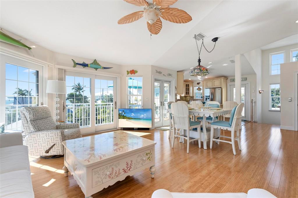 106 79th Street Holmes Beach, FL 34217 - Photo 15 of 98 a living room with furniture dining table and a large window