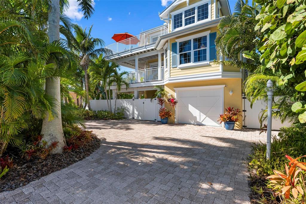 106 79th Street Holmes Beach, FL 34217 - Photo 3 of 98 a front view of a house with a yard