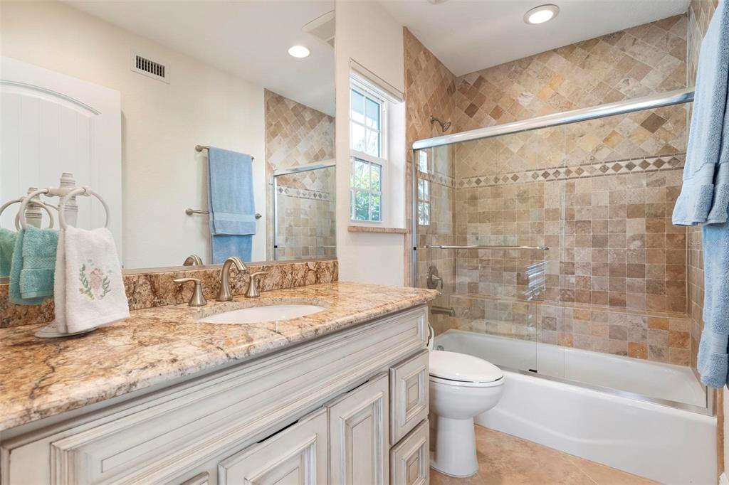 106 79th Street Holmes Beach, FL 34217 - Photo 45 of 98 a bathroom with a granite countertop sink toilet and shower