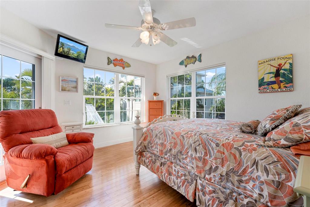 106 79th Street Holmes Beach, FL 34217 - Photo 46 of 98 a bedroom with furniture and a large window