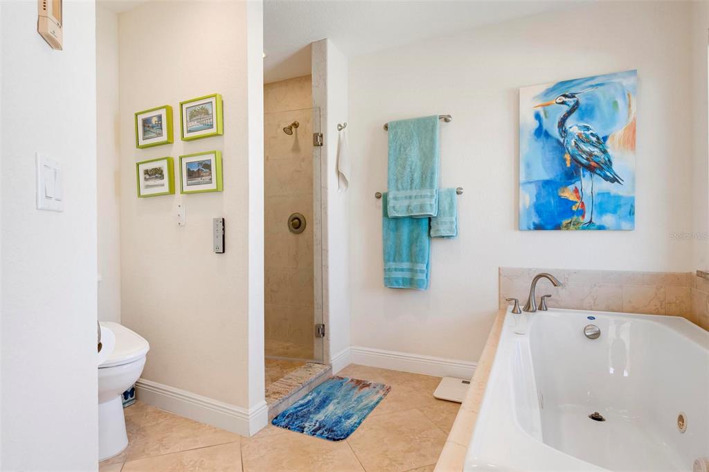 106 79th Street Holmes Beach, FL 34217 - Photo 51 of 98 a bathroom with a tub and a shower