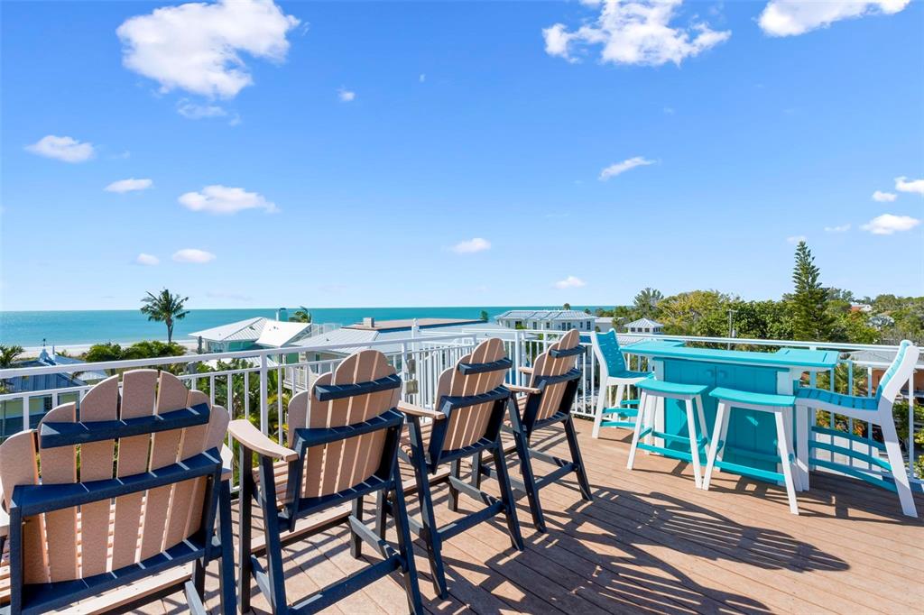 106 79th Street Holmes Beach, FL 34217 - Photo 56 of 98 a view of a chairs and table in patio