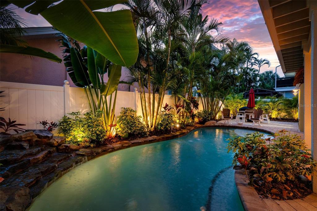 106 79th Street Holmes Beach, FL 34217 - Photo 78 of 98 a view of a swimming pool with a lawn chairs and potted plants