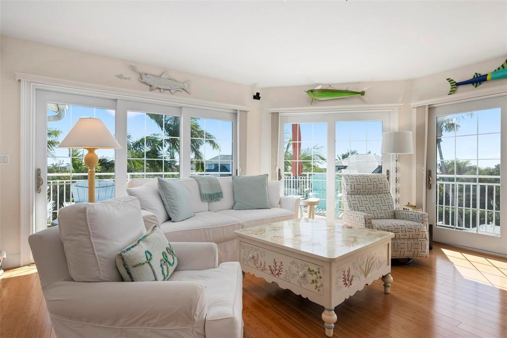 106 79th Street Holmes Beach, FL 34217 - Photo 8 of 98 a living room with furniture a table and a large window