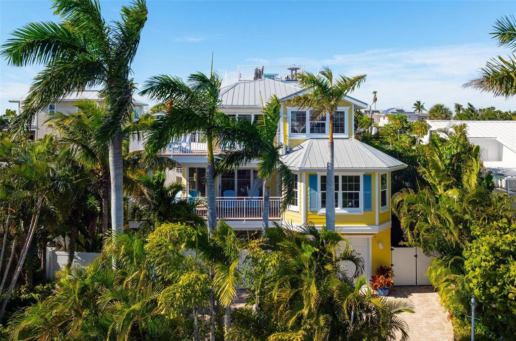 106 79th Street Holmes Beach, FL 34217 - Photo 84 of 98 a front view of a house with a garden