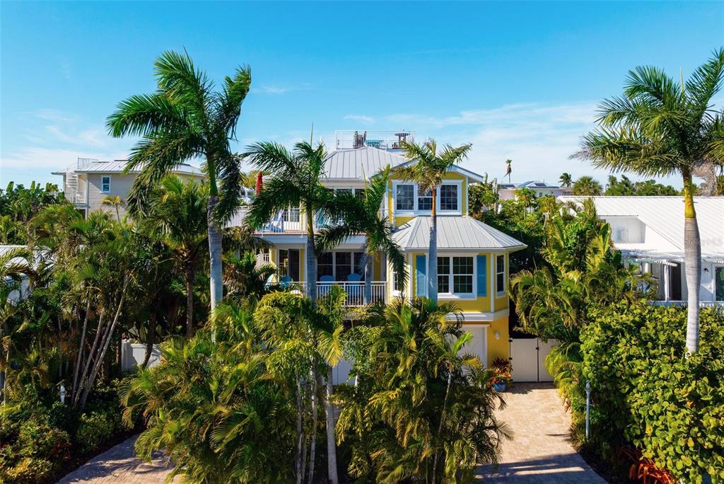 106 79th Street Holmes Beach, FL 34217 - Photo 85 of 98 a front view of a house with a garden