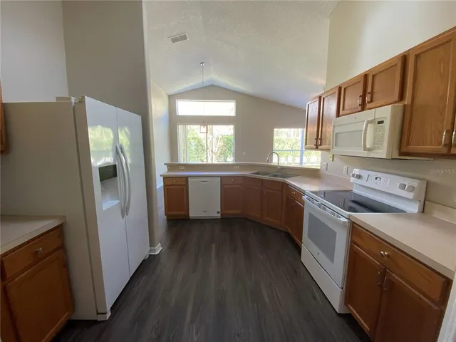 a kitchen with a refrigerator and a sink