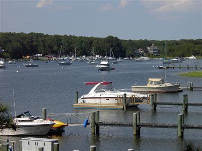 Undisclosed Address Marstons Mills, MA 02648 - Photo 11 of 11 a view of a swimming pool with a table and chairs
