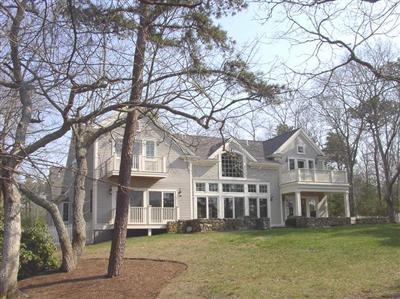 Undisclosed Address Marstons Mills, MA 02648 - Photo 2 of 11 a front view of a building with a yard