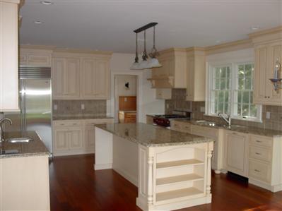 Undisclosed Address Marstons Mills, MA 02648 - Photo 6 of 11 a kitchen with a sink dishwasher a stove and white cabinets with wooden floor