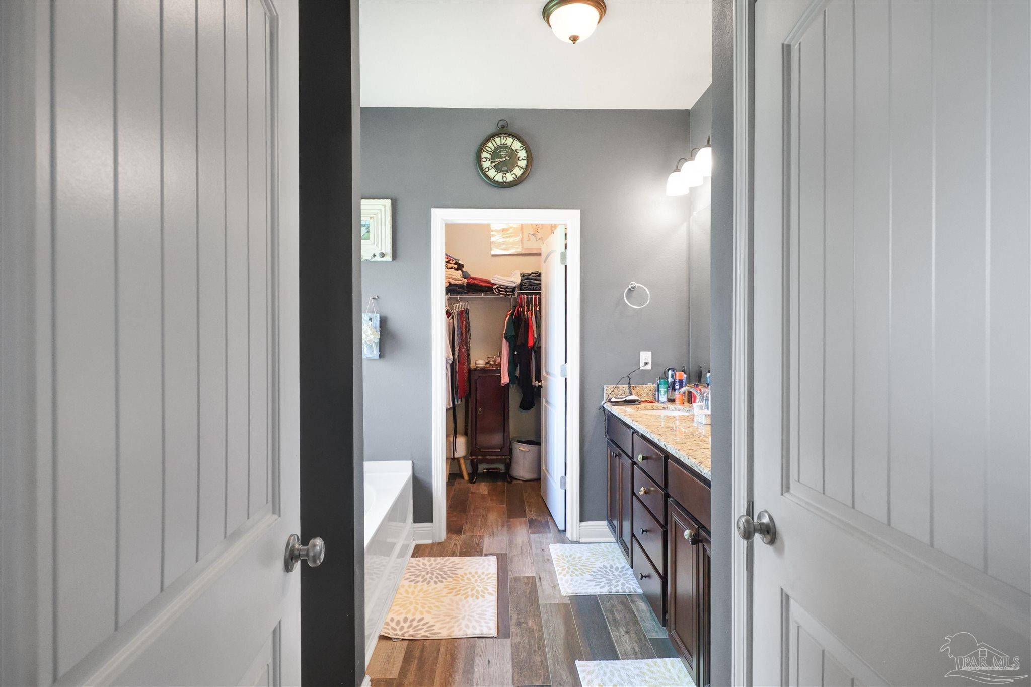 6377 Ladera Trail Pace, FL 32571 - Photo 14 of 38 a view of a hallway to a livingroom with furniture