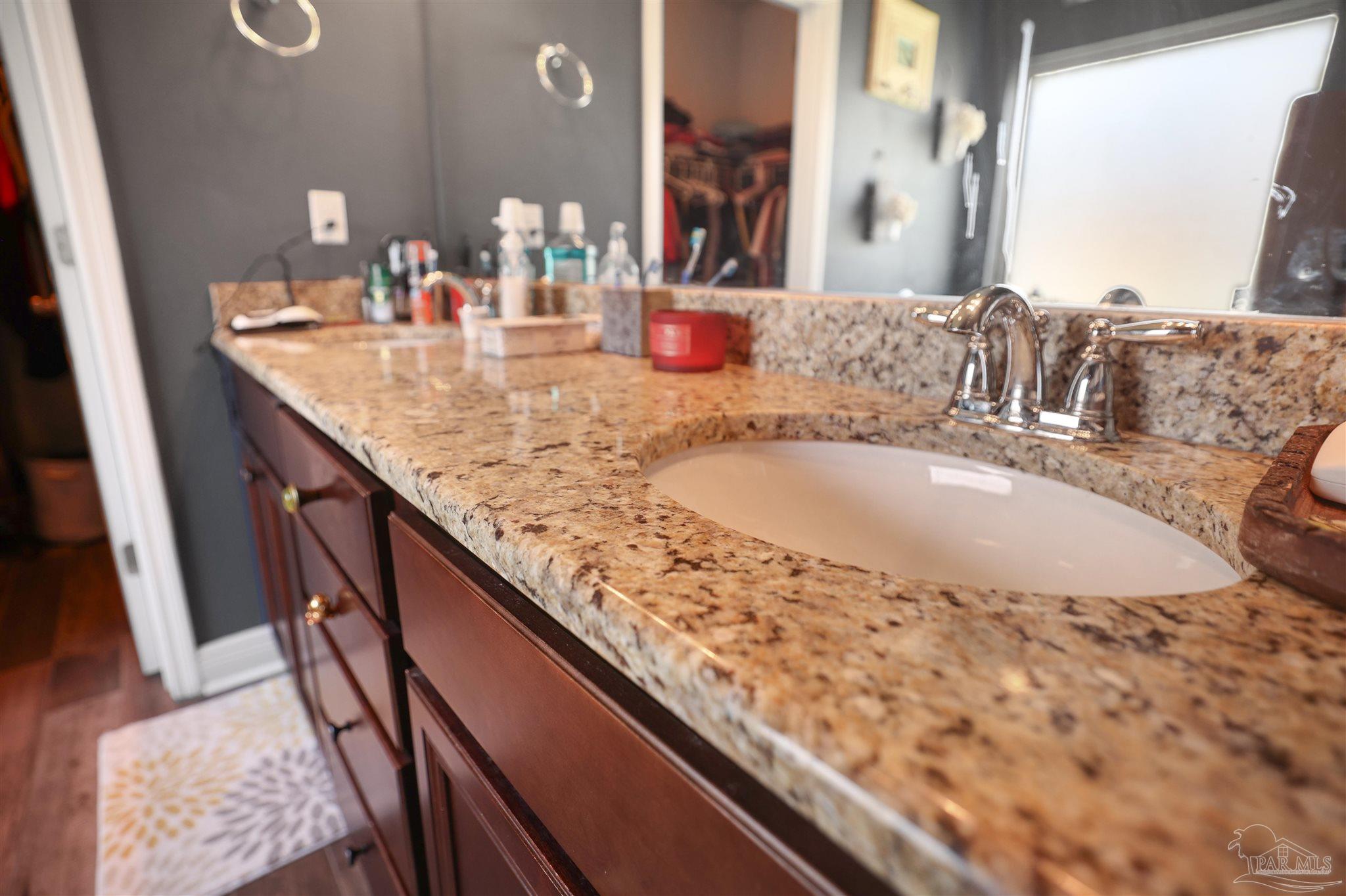 6377 Ladera Trail Pace, FL 32571 - Photo 17 of 38 a bathroom with a granite countertop sink and a large mirror