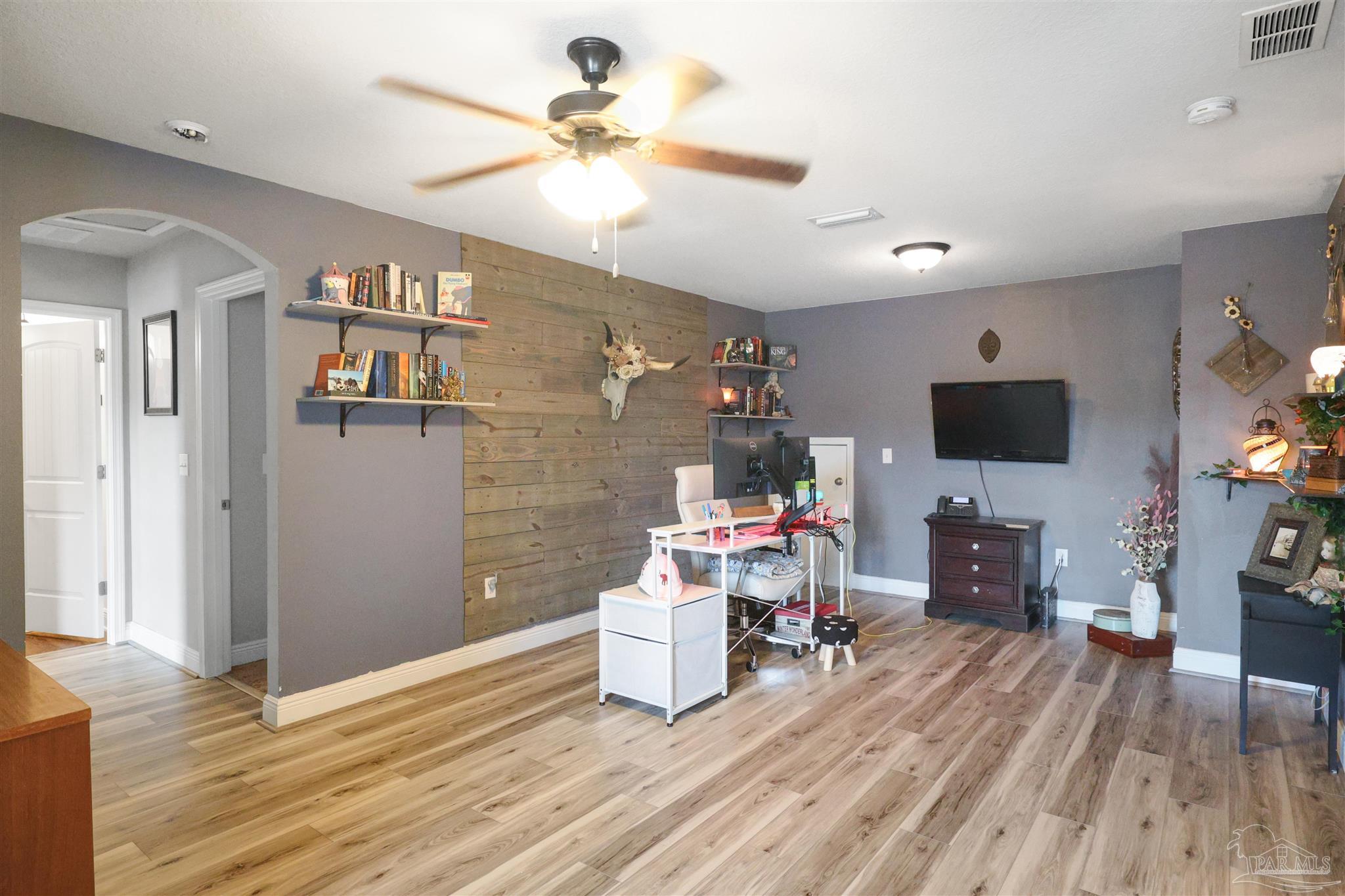 6377 Ladera Trail Pace, FL 32571 - Photo 18 of 38 a living room with furniture and a flat screen tv