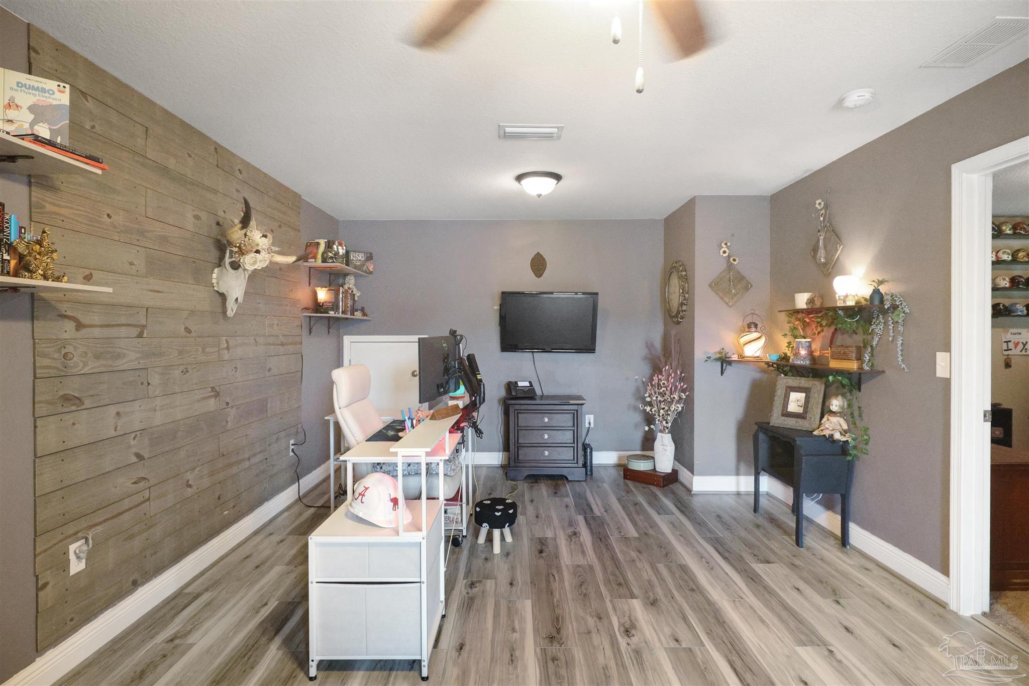 6377 Ladera Trail Pace, FL 32571 - Photo 19 of 38 a living room with furniture and a flat screen tv