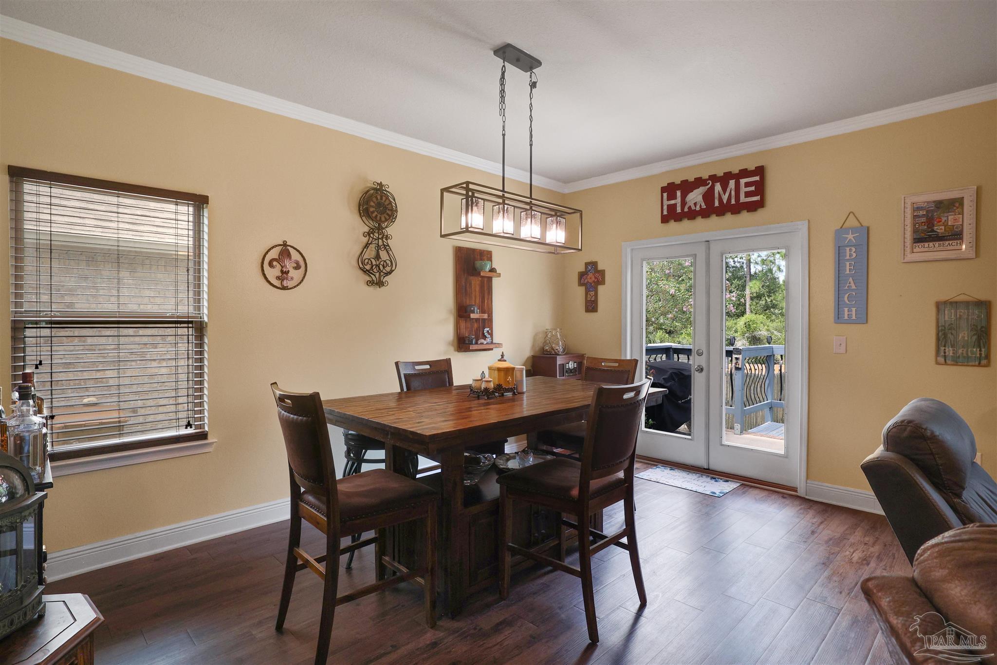 6377 Ladera Trail Pace, FL 32571 - Photo 24 of 38 a view of a dining room with furniture window and wooden floor